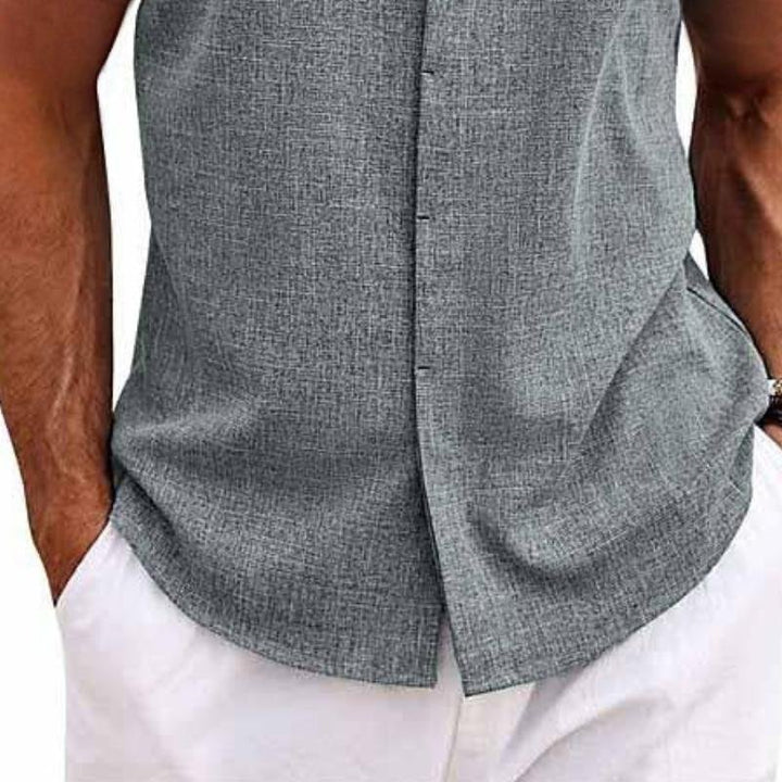Relaxed fit men's sleeveless button-down tank top, excellent for beach trips, outdoor style, and warm weather.