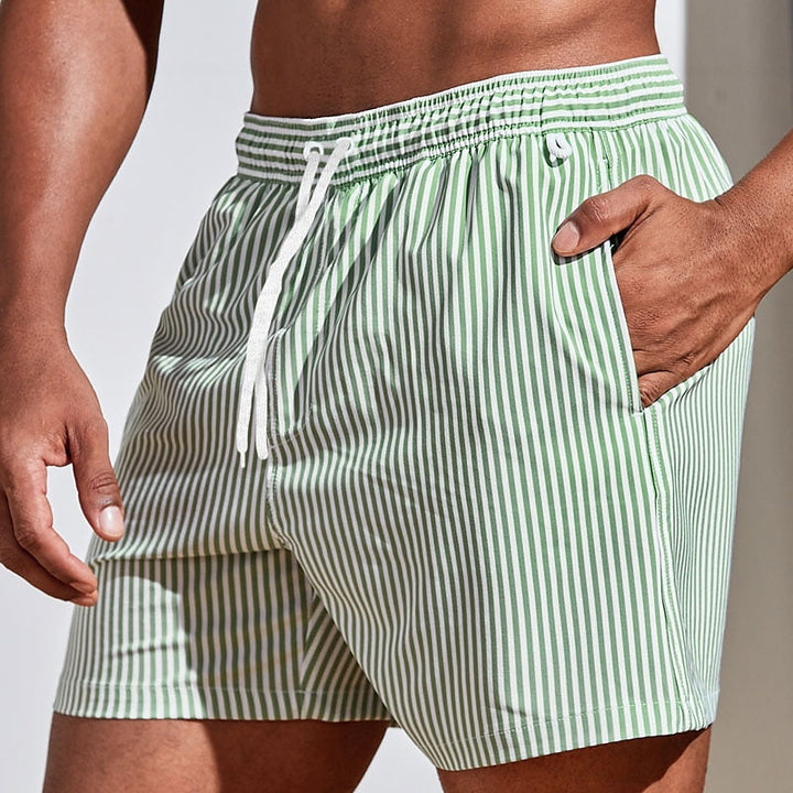 Fashion-forward men's striped beach shorts with practical drawstring. Great for summer activewear.