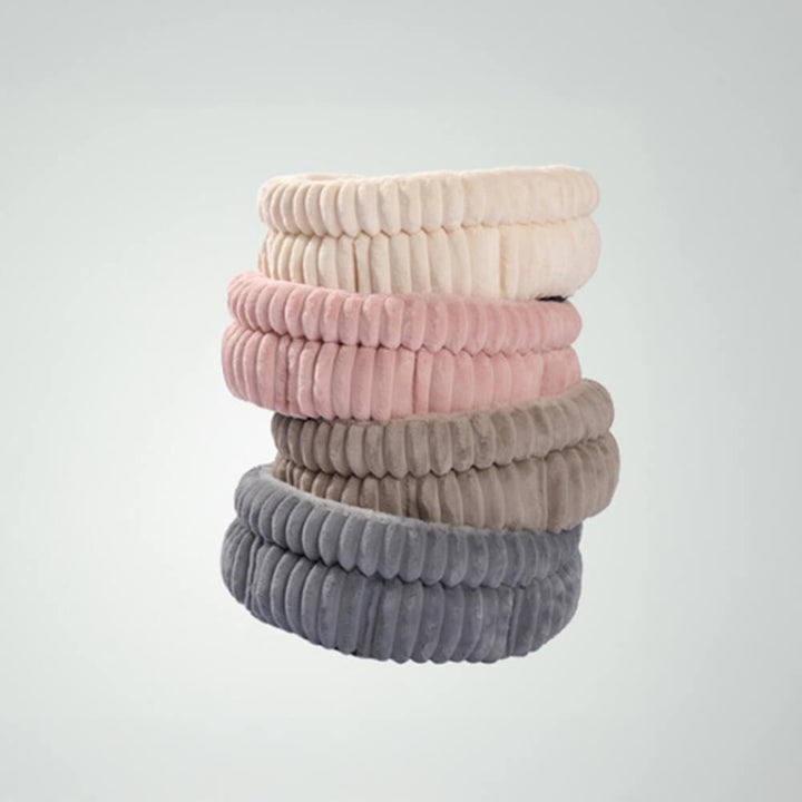 Modern minimalist pet bed in a neutral tone, providing warmth and anxiety relief for pets