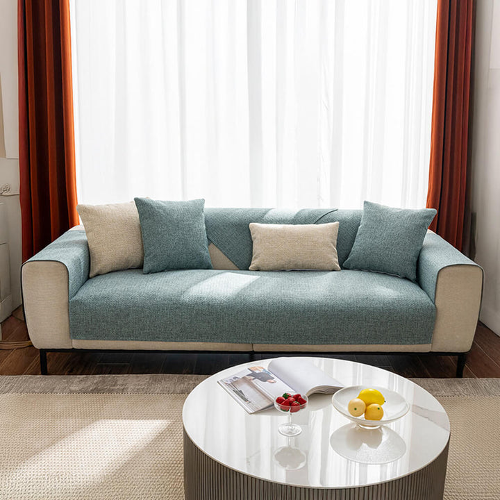 Modern solid green couch cover protector, breathable design for a pet friendly and minimalist home.