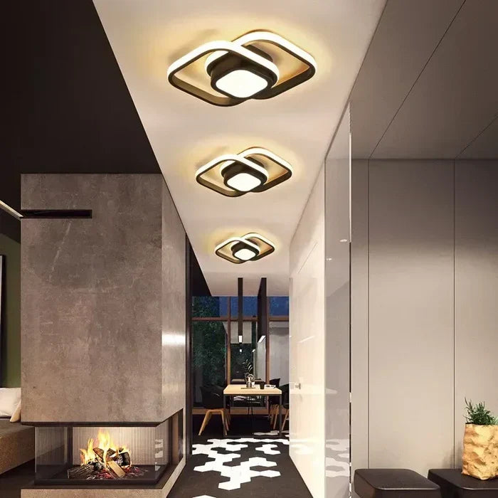 Sleek black modern LED ceiling lamp, unique dual ring design. Decorative contemporary lighting for any room.