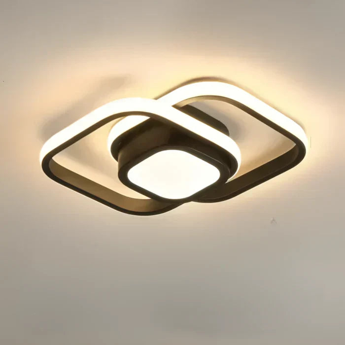 Modern LED ceiling lamp for living rooms. Elegant dual ring design provides contemporary, energy-saving light.