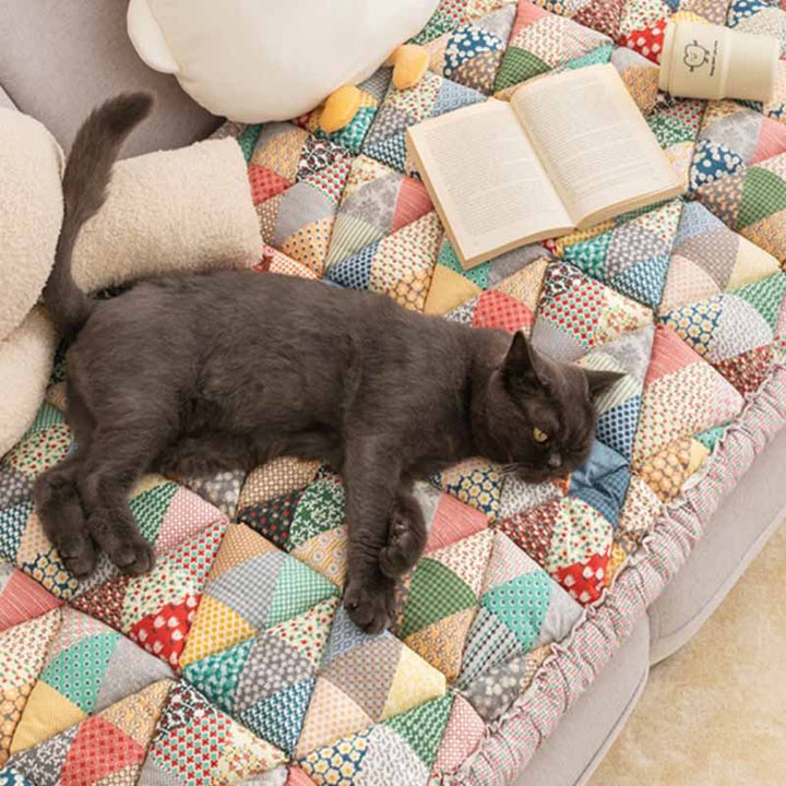 Quilted cotton sofa protector, pet-friendly, non-slip, in a cozy home decor setting