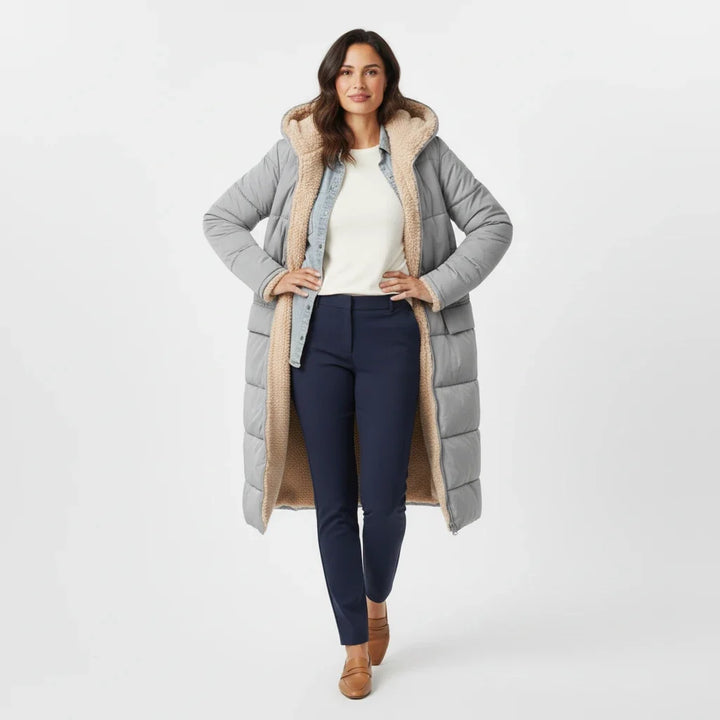 Long women's puffer coat, hooded and insulated for severe winter conditions.