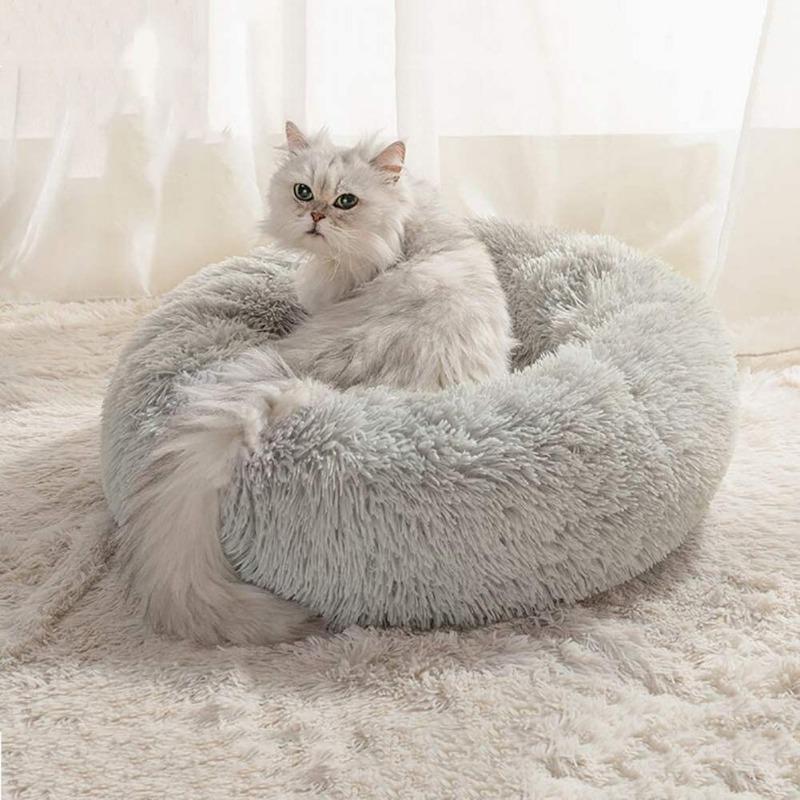 Plush grey calming cat donut bed with raised rim for anxiety relief