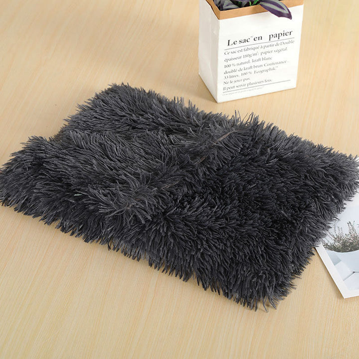 Plush pet blanket being machine washed, highlights its washable feature for easy care