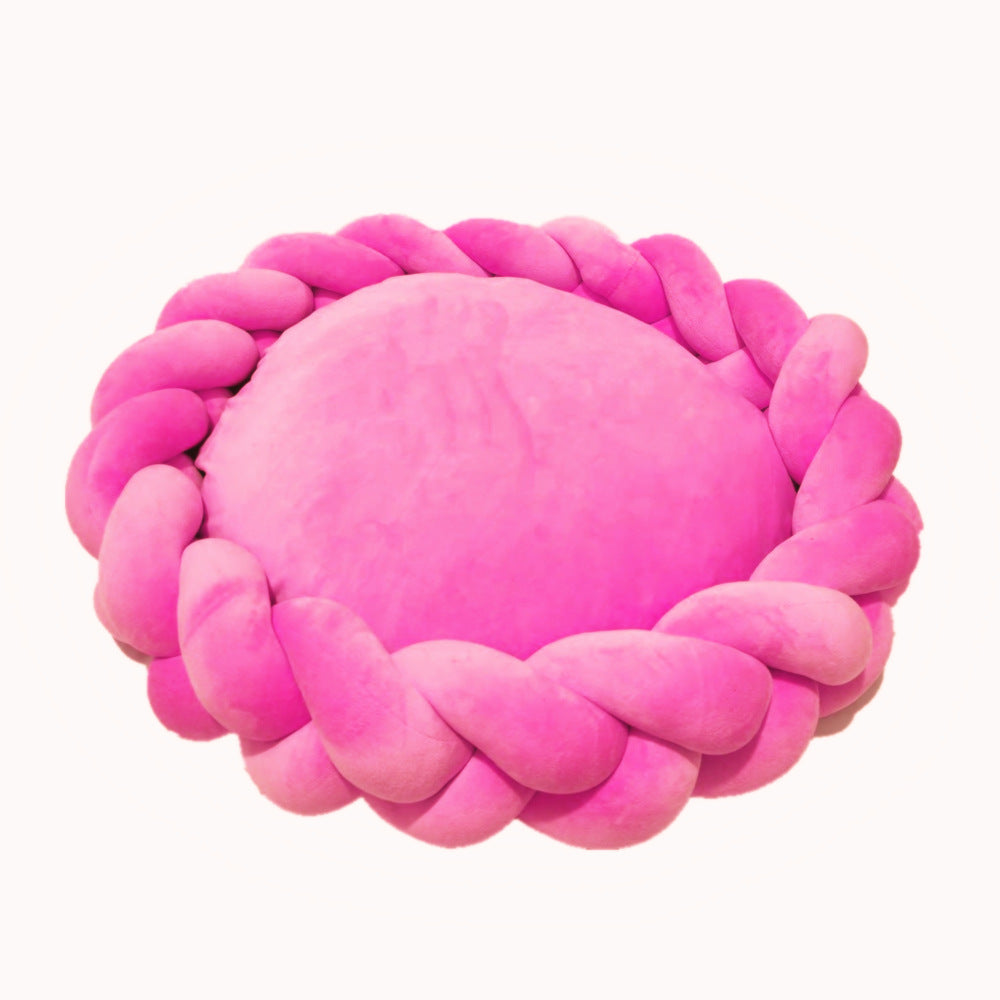 Stylish pet bed: a luxury plush dog bed with sophisticated braided bolster design.