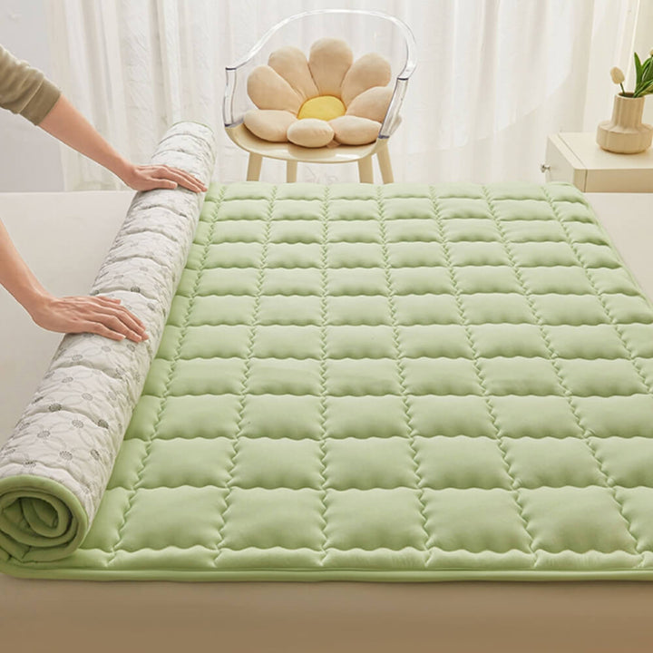 Close-up of breathable fabric on a quilted mattress topper, non-slip design