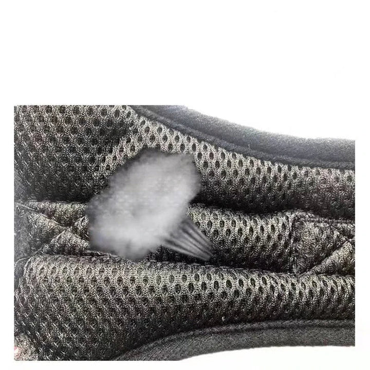 Close-up of an adjustable no-pull dog harness, highlighting reflective stitching for night safety.