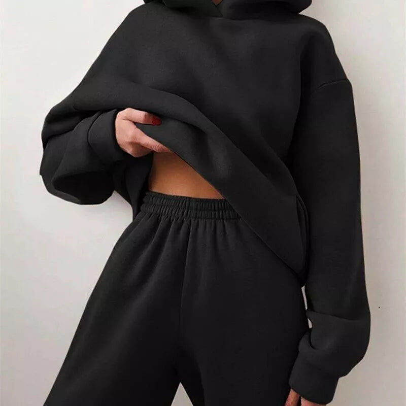 Woman wearing a comfortable Serenity oversized hoodie & jogger set, ideal for relaxed loungewear or casual style.