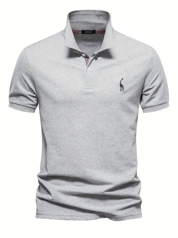 Modern men's golf polo, short sleeve, offering comfort & classic style, highlighted by an embroidered giraffe.