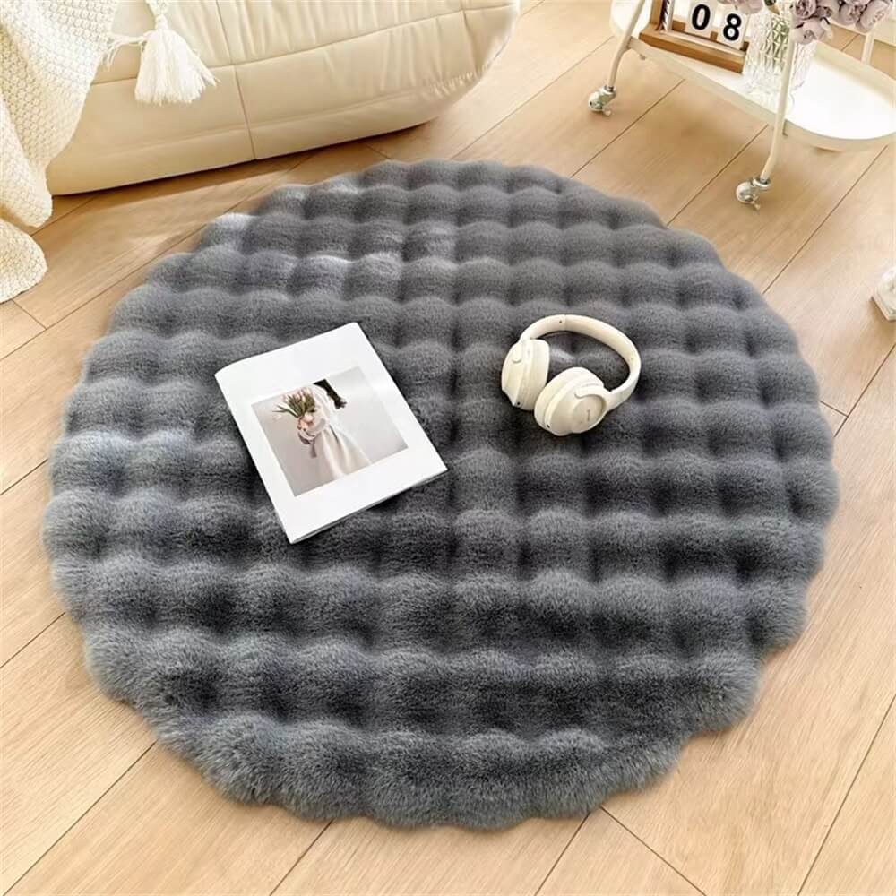 Creamy round plush carpet, a chunky and cozy accent for any living room or bedroom