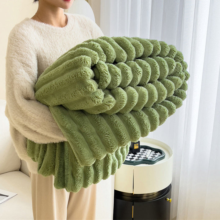 Stylish plush faux fur throw blanket enhancing the comfort of a living room sofa.