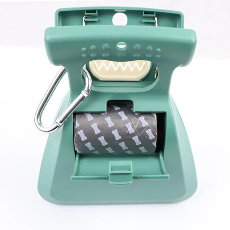 Portable dog scooper for pet waste, shown folded with a roll of biodegradable bags for cleanup