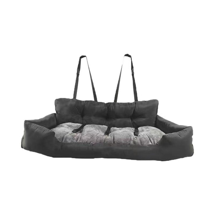 Puppy looking out window from a console booster seat, indicating dog accessories for comfortable travel.