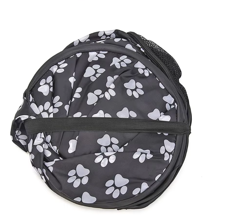 Comfortable dog accessory: portable soft crate featuring paw designs, designed for optimal pet ventilation.