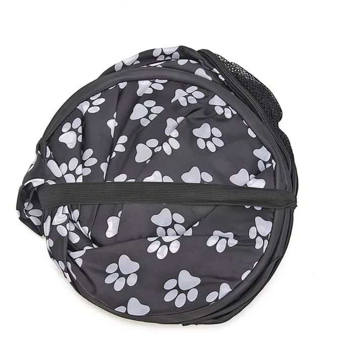 Comfortable dog accessory: portable soft crate featuring paw designs, designed for optimal pet ventilation.