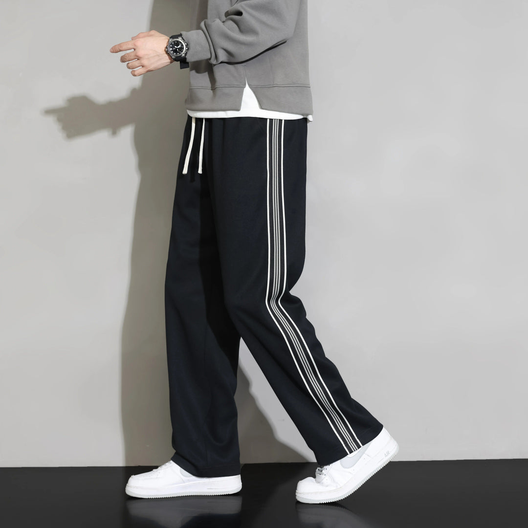 Men's relaxed fit leisure stripe joggers. Soft polyester casual pants with drawstring for comfort.