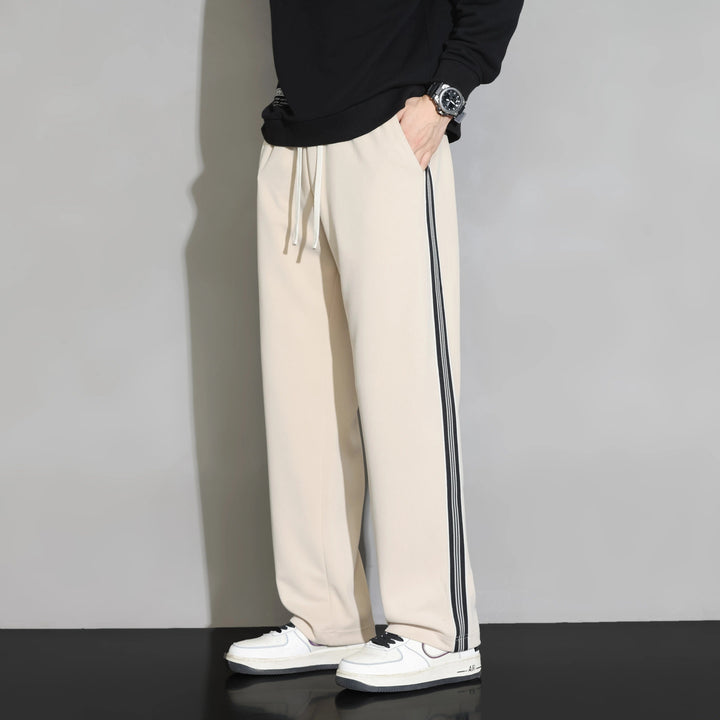 Soft polyester men's joggers, relaxed fit, with comfortable drawstring waist for leisurewear.