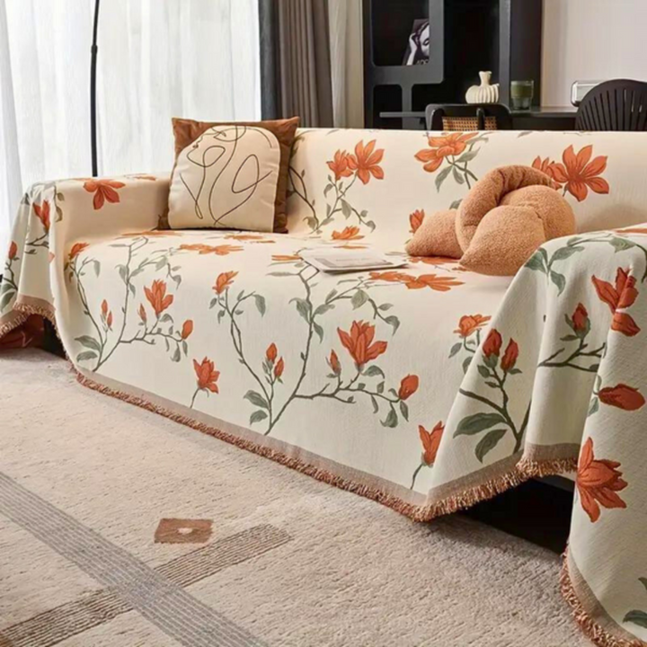 Chenille sofa cover with a vintage floral pattern and tassel detail, perfect for cozy living rooms.