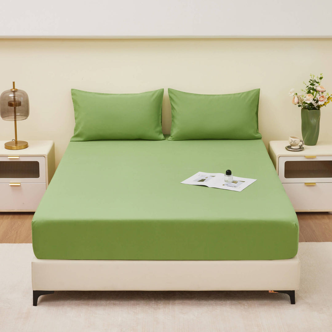 Hand touching a waterproof fitted sheet, illustrating the skin-friendly material and softness.