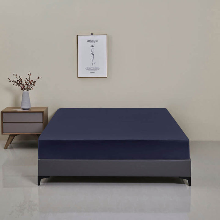 Stack of folded waterproof fitted sheets, indicating easy storage and high-quality home textiles.