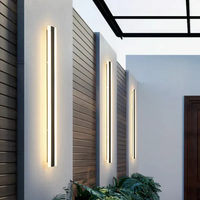 Sleek LED outdoor wall lamp for garden and patio. Weather-resistant exterior light, enhancing home decor.