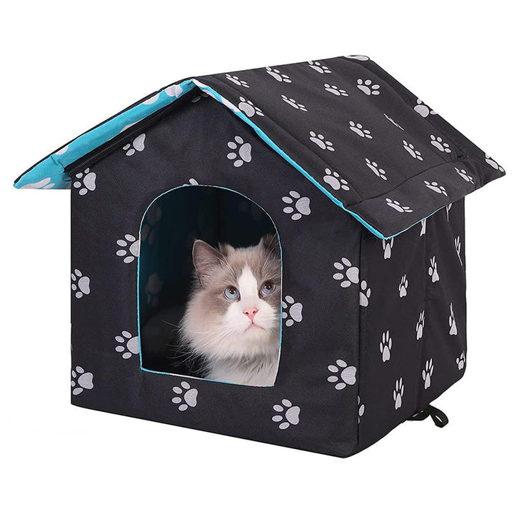 Outdoor cat house with self-warming pad, durable and weatherproof for all seasons.