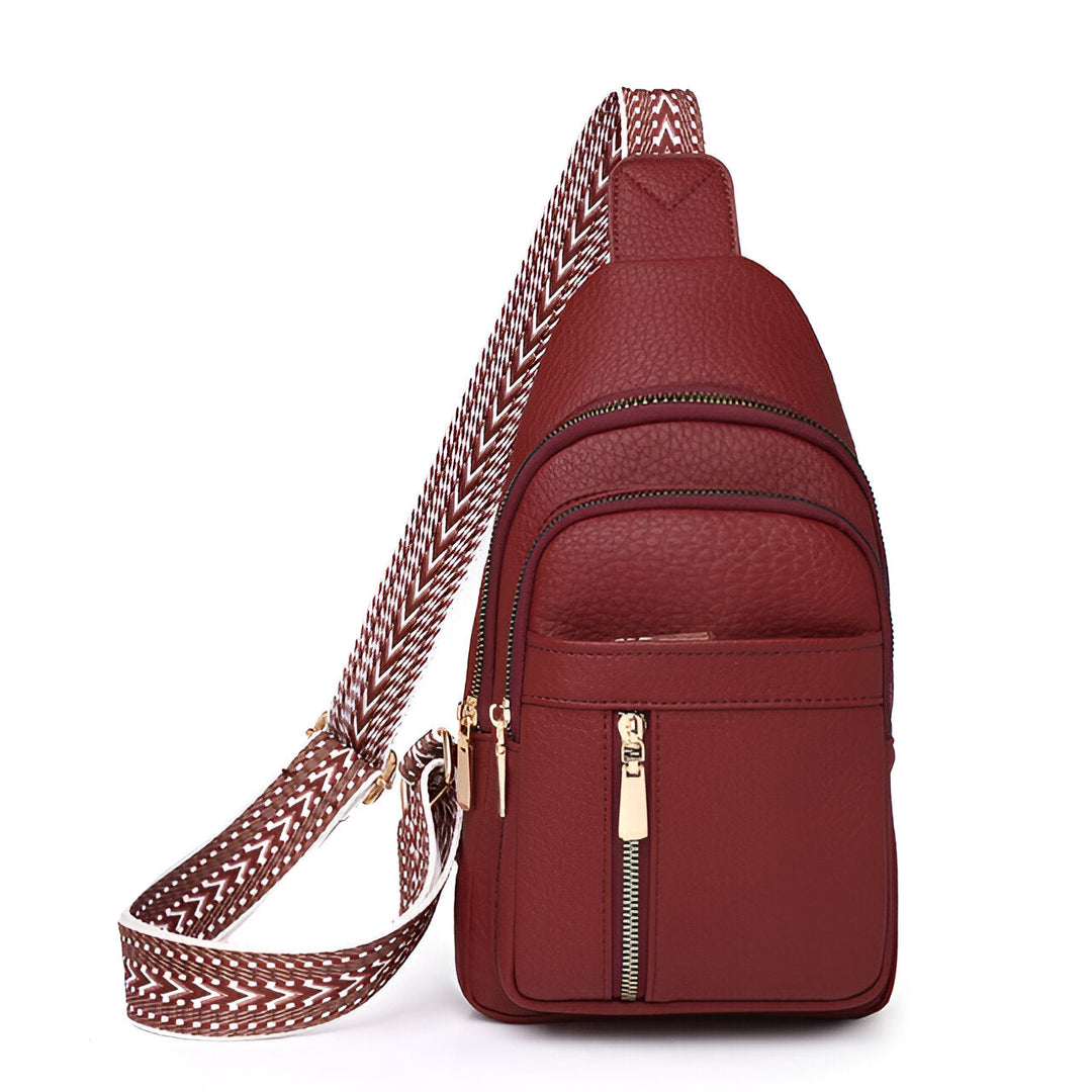 Compact women's anti-theft sling bag, available in multiple colors. Features a stylish patterned strap, perfect for travel.
