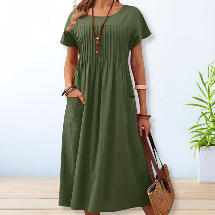 Flowy women's relaxed fit midi dress with pockets, ideal for comfortable casual wear & versatile summer styling.