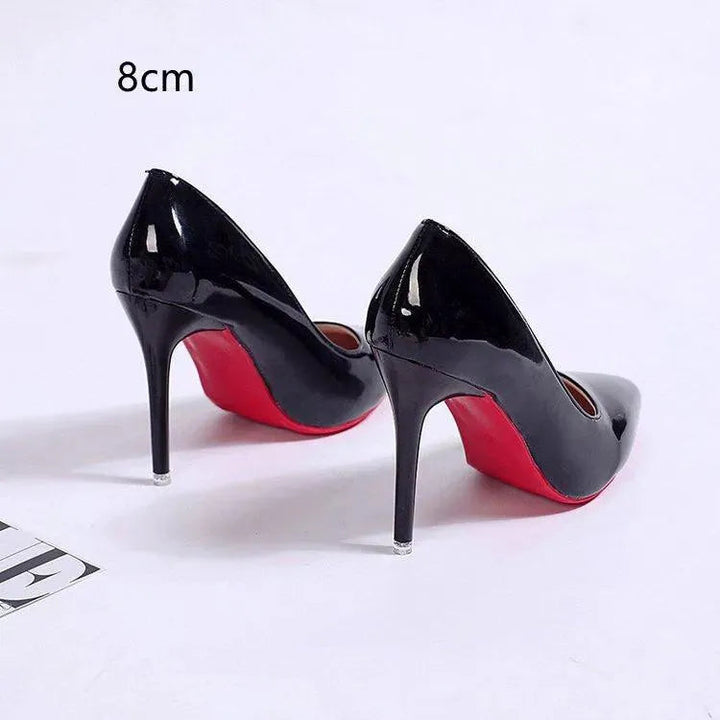 Fashionable women's black stiletto pumps with a sleek pointed toe design, formal footwear.