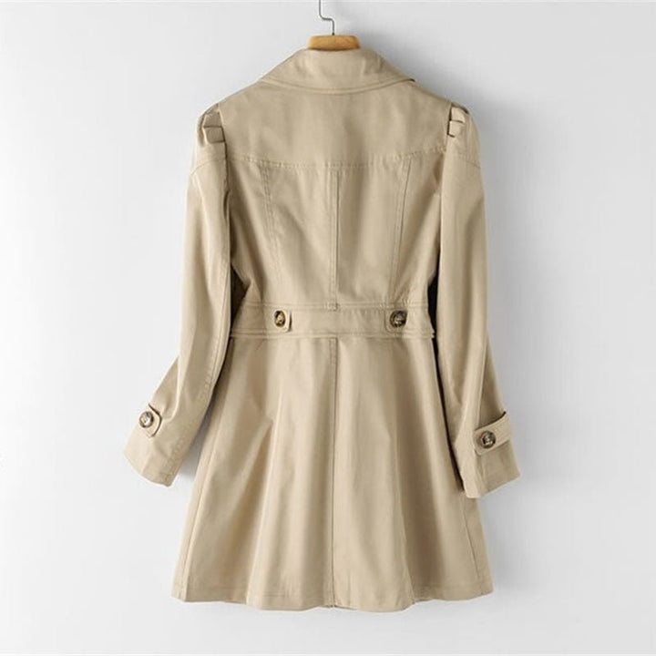 Elegant women's tailored trench coat, classic outerwear for versatile transitional weather and sophisticated style.