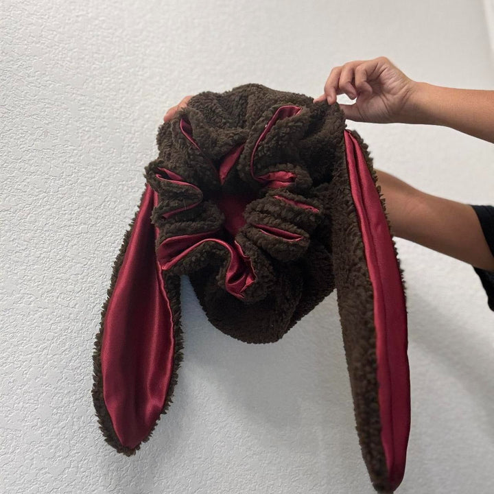 Cozy women's bunny bonnet, soft plush hat, offers warmth & hair protection, perfect for cold weather.