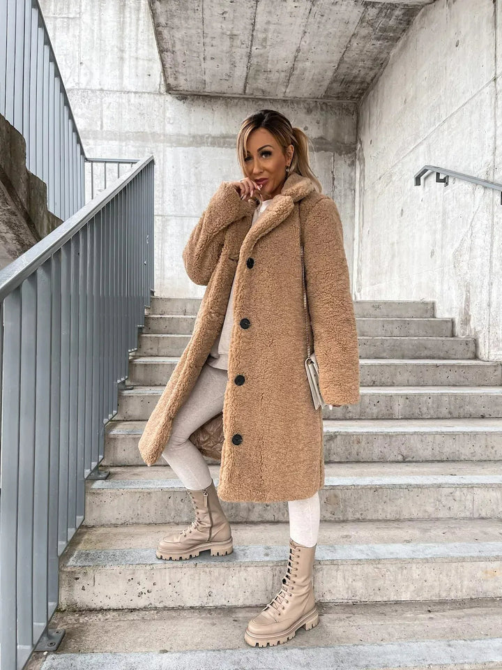 Chic women's longline teddy coat, a stylish faux fur jacket for cool weather fashion.