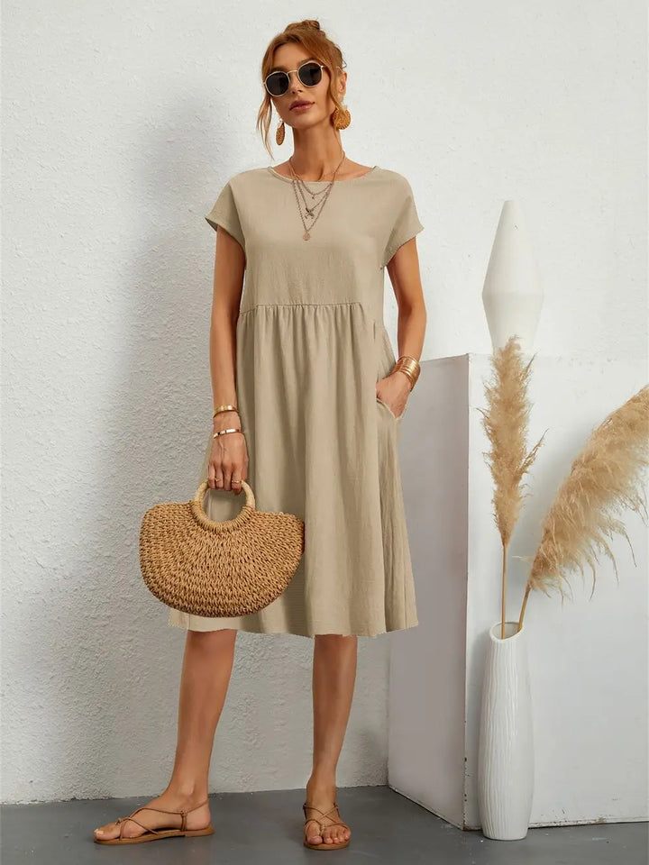 Relaxed fit pocketed midi dress for women, offering chic style and comfort for daily activities.