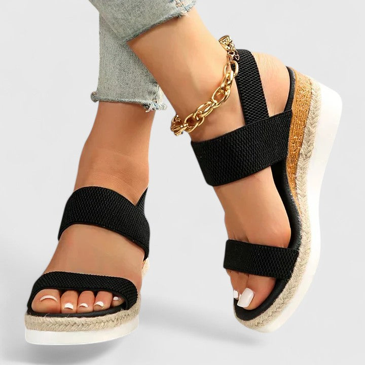 Comfortable women's wedge sandals with an espadrille sole and elastic open-toe straps for easy slip-on.