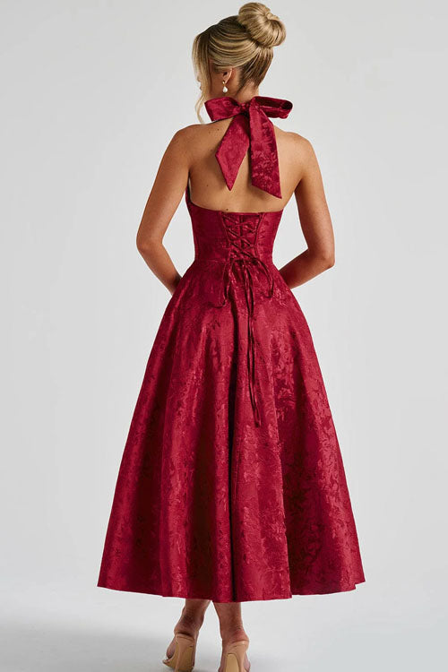 Side profile: Women's sophisticated A-line maxi dress with a halterneck. Ideal for prom or galas.