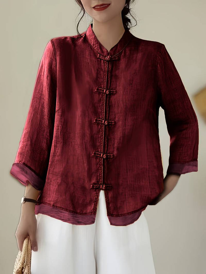 Stylish white mandarin collar blouse with unique frog buttons & 3/4 sleeves for office or casual.