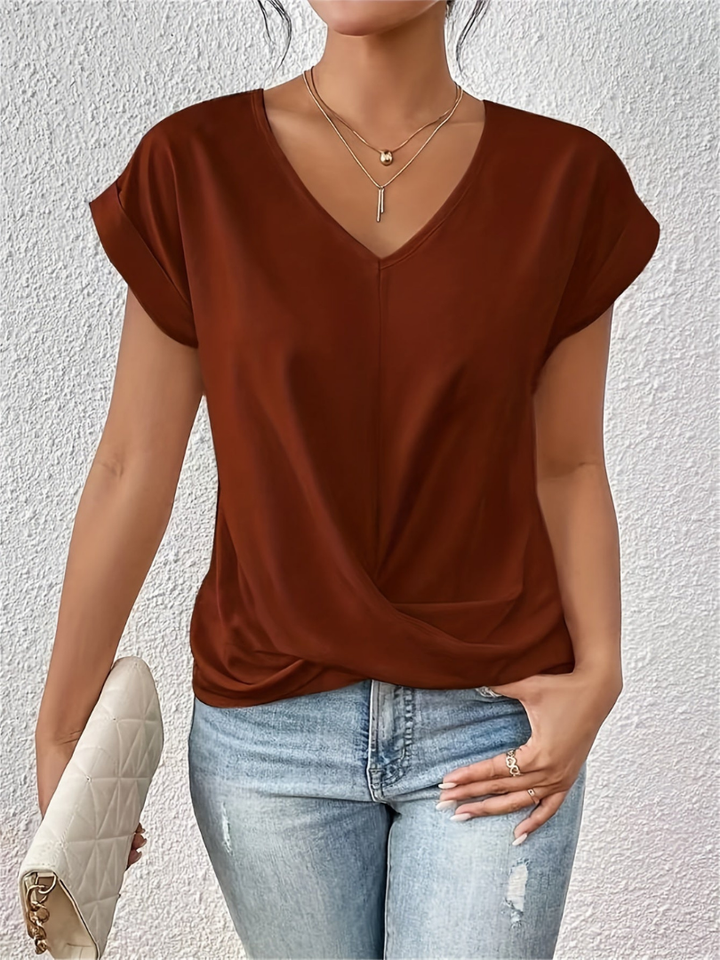 Versatile women's fashion top. Everyday chic short sleeve, V-neck, twist-front design.