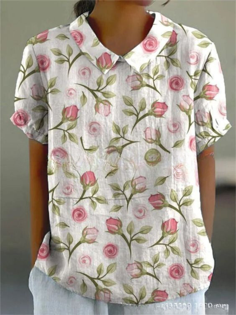 Stylish women's Peter Pan collar blouse, featuring intricate floral embroidery & short sleeves.