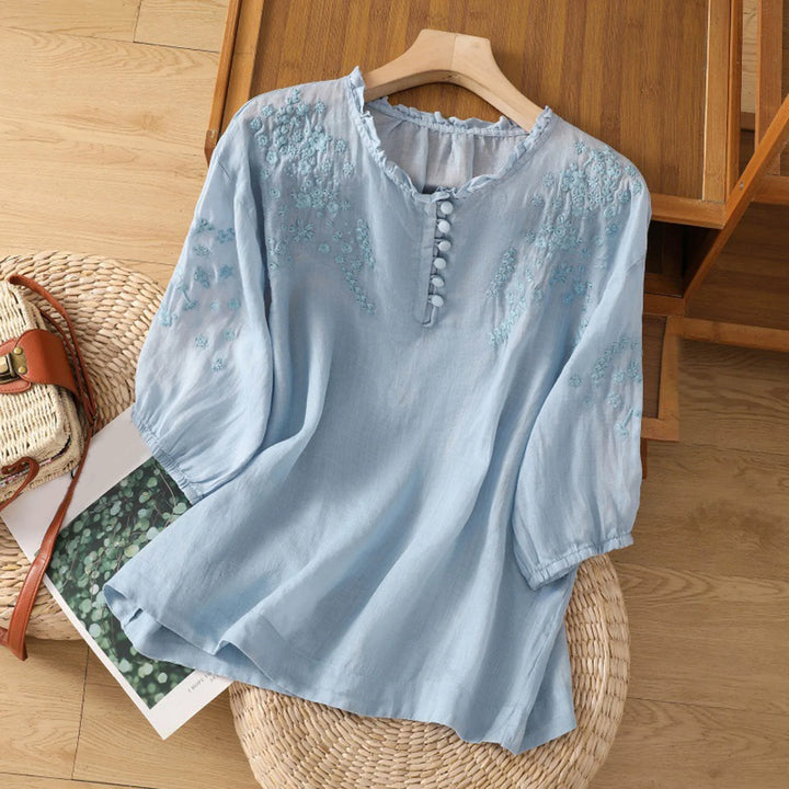 Women's embroidered short sleeve blouse with a relaxed fit and button neckline, perfect for casual summer style.
