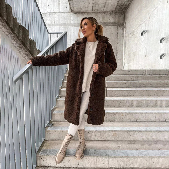 Women's long cozy teddy coat in a plush texture, perfect for ultimate winter warmth and stylish outerwear.