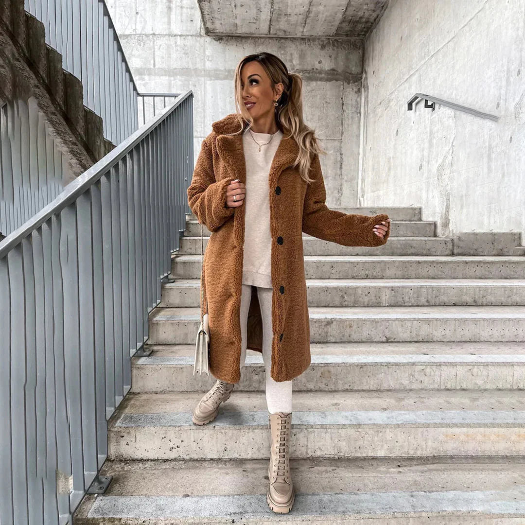Elegant women's longline teddy coat, a fashionable and warm winter outerwear piece for a cozy look.