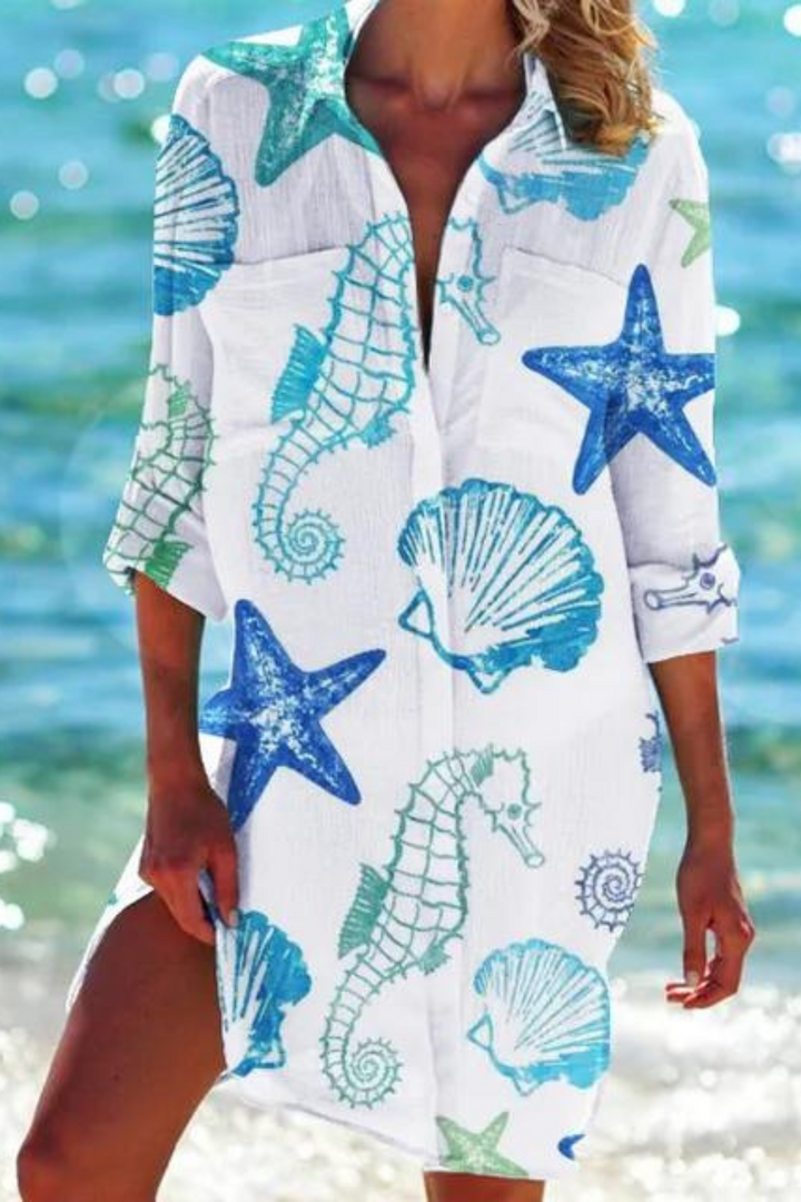 Longline women's beach cover up with an eye-catching seashell & coral print, perfect for summer resort wear.
