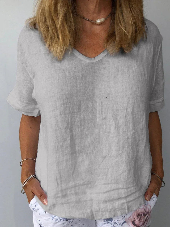 Casual women's short sleeve blouse featuring a comfortable relaxed fit and flattering V-neck design.