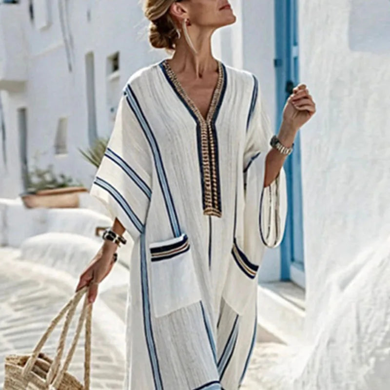 Elegant women's flowy striped kaftan dress, perfect for summer vacation, beach, or resort fashion.