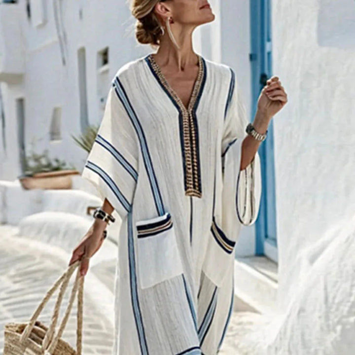 Elegant women's flowy striped kaftan dress, perfect for summer vacation, beach, or resort fashion.