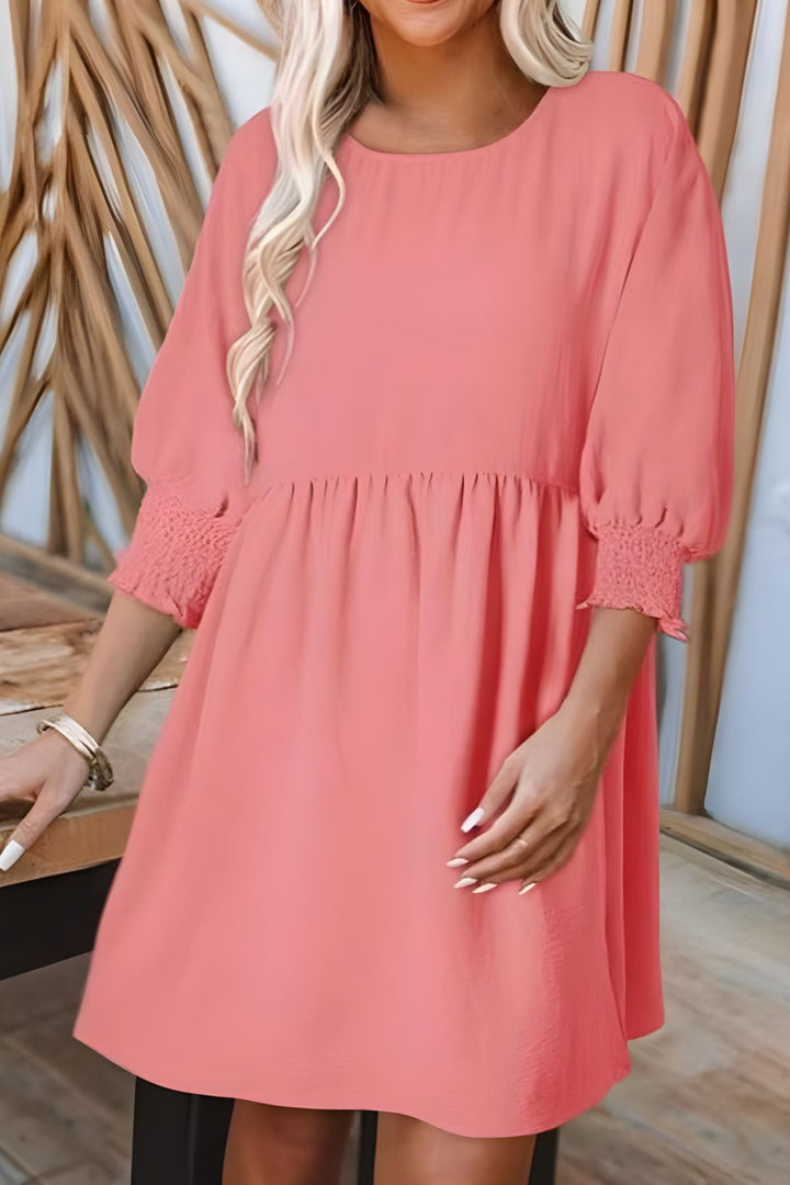 Flattering women's babydoll mini dress with a flared skirt, smocked half sleeves & playful ruffles.