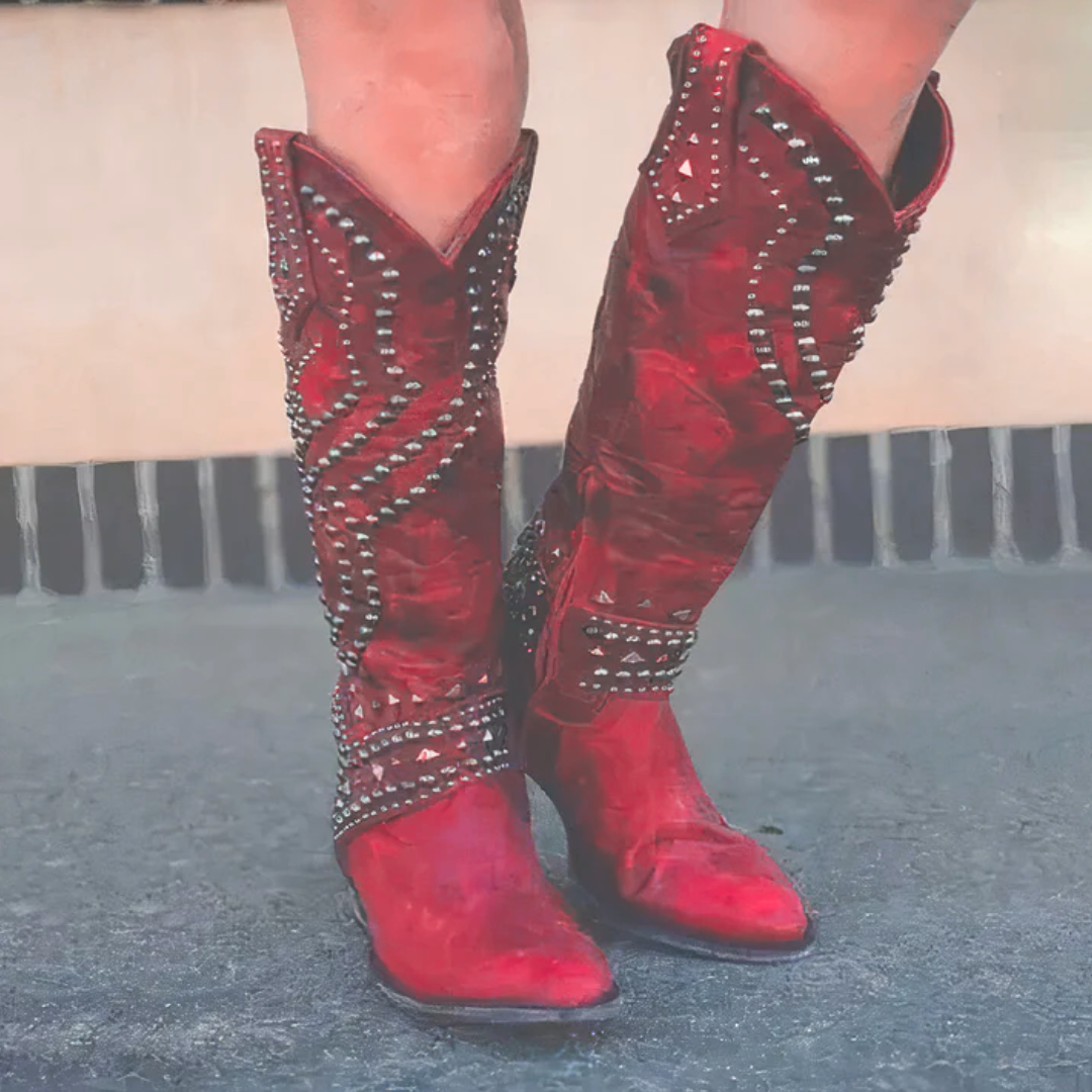 Fashionable women's studded knee-high western cowboy boots, a bold statement piece with western charm.