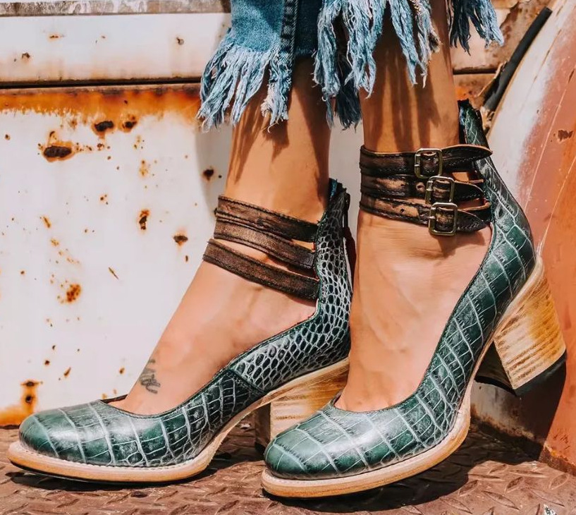 Fashionable women's pumps with an ankle strap, robust block heel, and comfortable round toe design.
